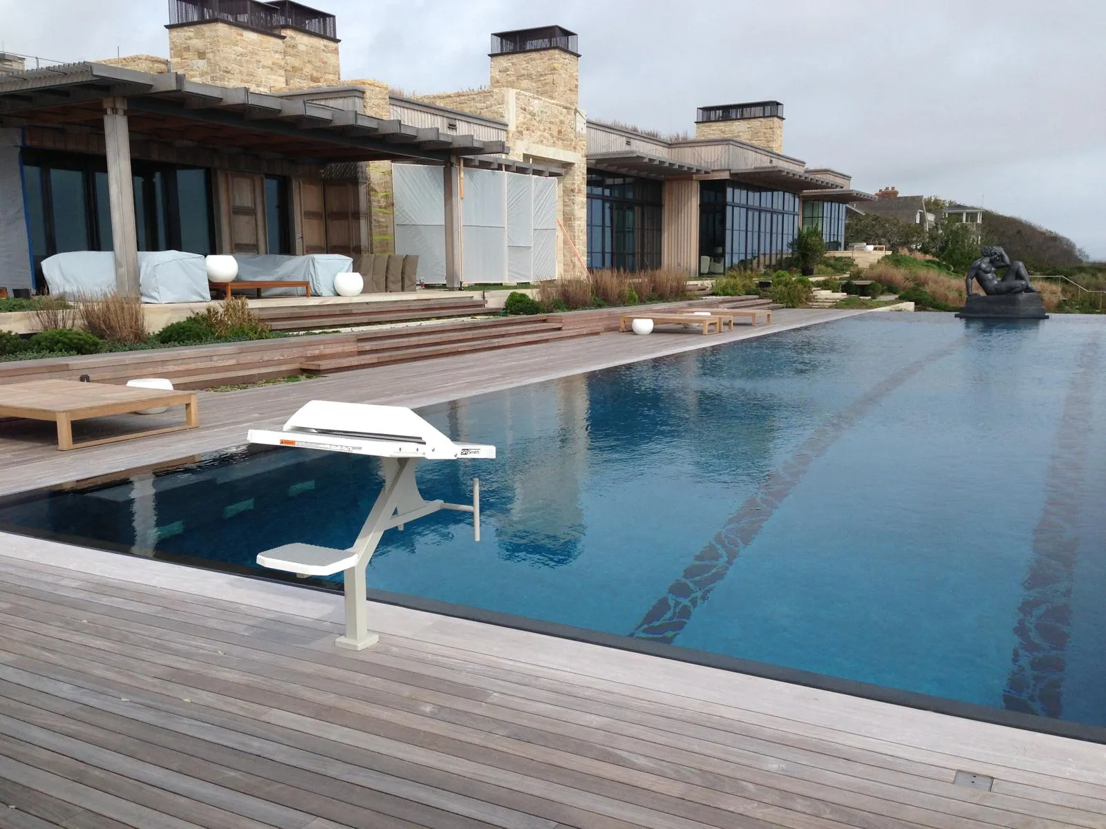 A lap pool with a starting block and a weathered cedar deck.